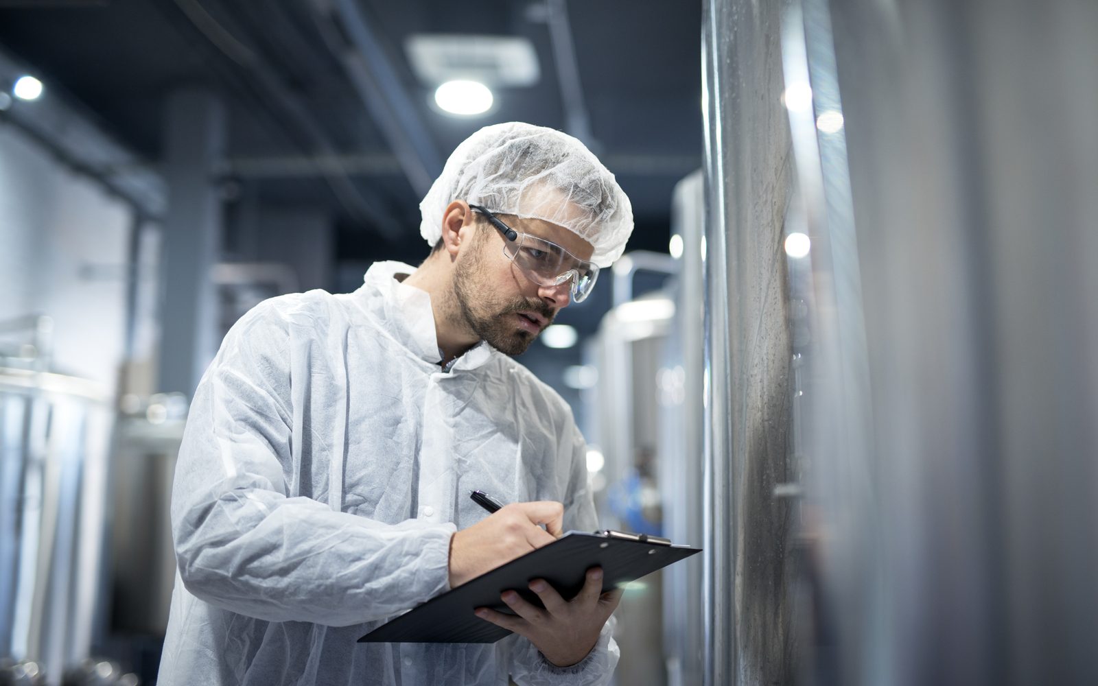 Process technologist logging progress on the production floor