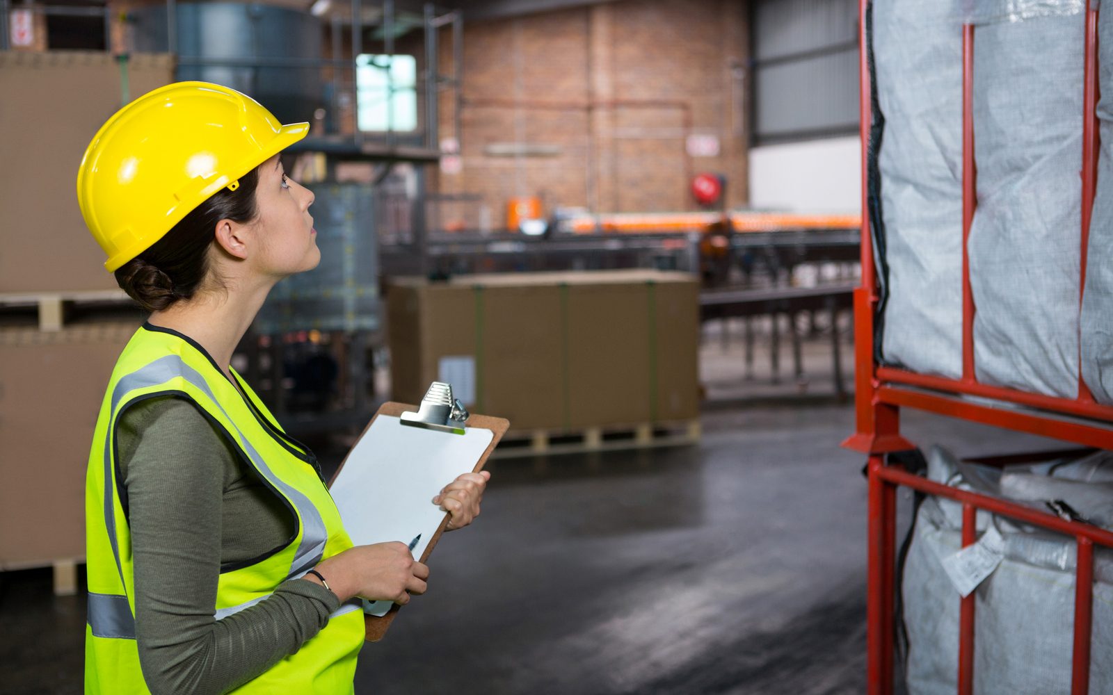 Warehouse supervisor examining finished goods before dispatch