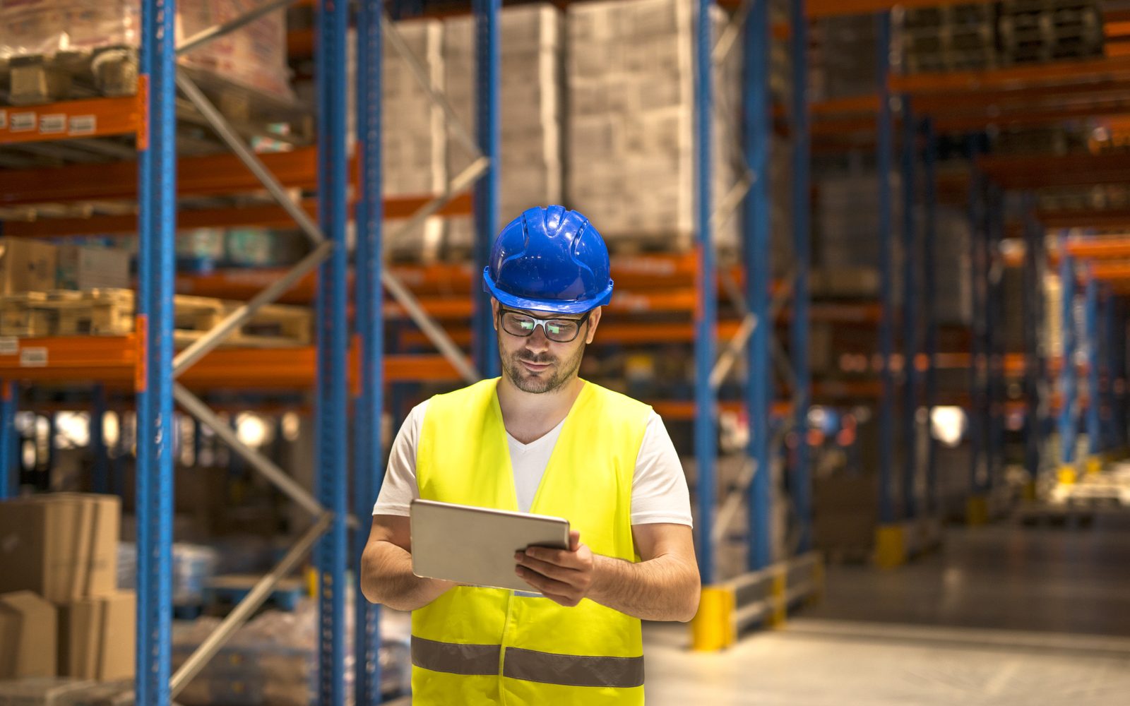 Production planner reviewing orders on a tablet in a materials store